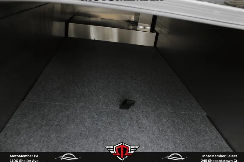 Slide: The Image of Interior storage compartment of 2026 SunCatcher Fusion 324SS, featuring carpeted flooring. - 23