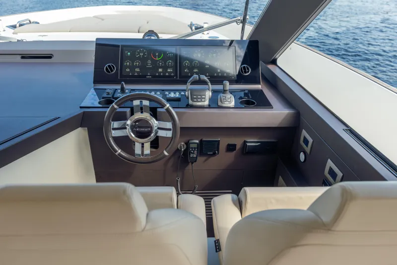 Slide: The Image of Helm of 2025 Azimut Seadeck 6 yacht with modern controls and ocean view. - 13