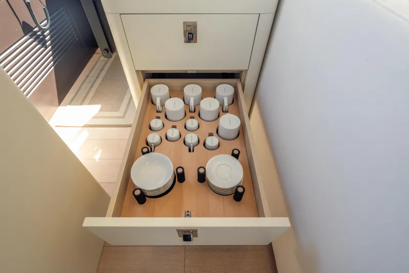 Slide: The Image of Drawer with neatly organized cups and plates on Azimut Seadeck 6 yacht, 2025 model. - 15