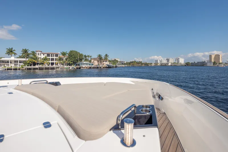 Slide: The Image of Azimut Seadeck 6 yacht, 2025 model, cruising near waterfront homes under a clear blue sky. - 27