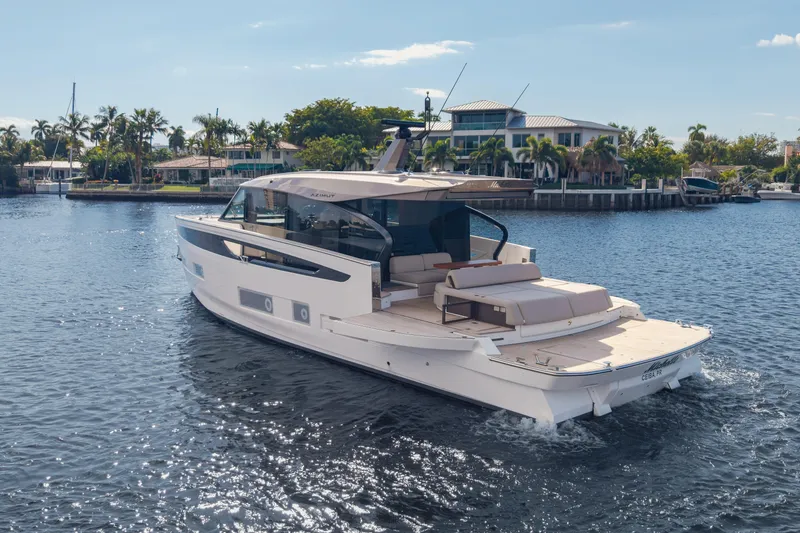 Slide: The Image of 2025 Azimut Seadeck 6 yacht cruising on a sunny waterfront, surrounded by palm trees. - 29