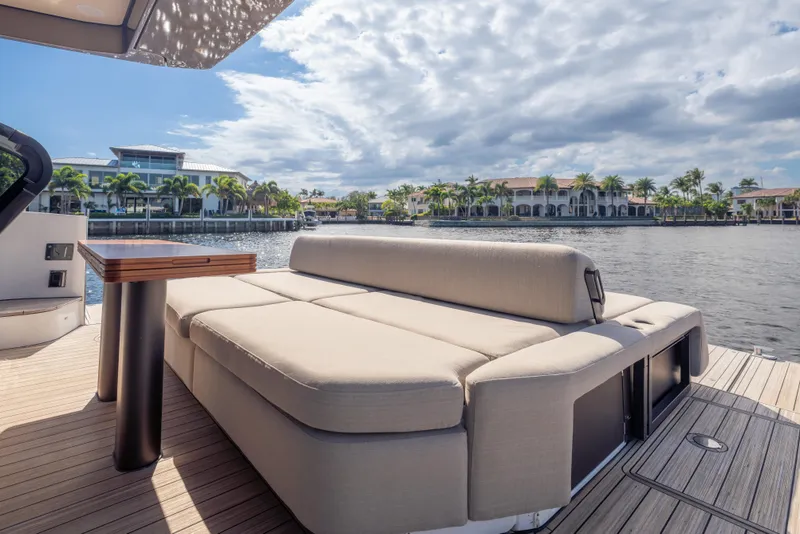 Slide: The Image of Luxurious Azimut Seadeck 6 yacht deck with plush seating, overlooking serene waterfront views. - 4