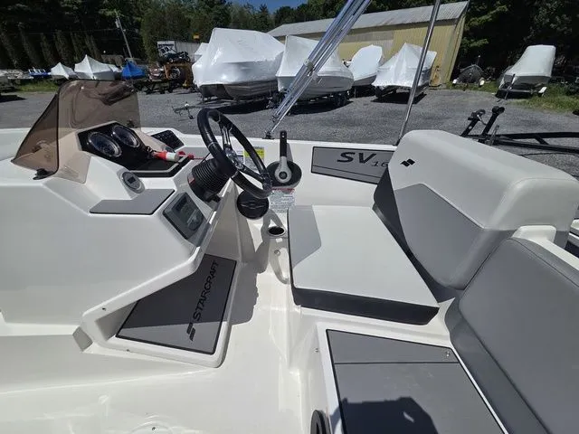 Slide: The Image of Interior of Starcraft 2025 SV 16 OB boat with steering console. - 16