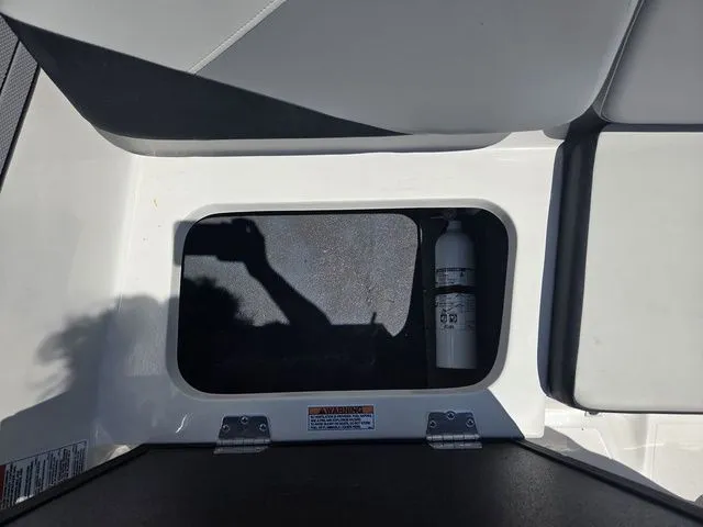 Slide: The Image of Storage compartment in Starcraft 2025 SV 16 OB boat with fire extinguisher. - 30