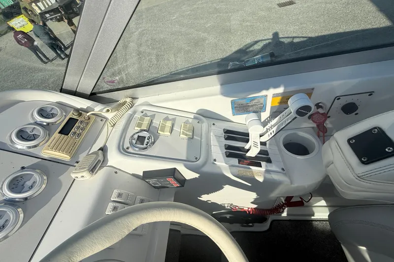 Slide: The Image of 1999 Formula 312 FASTech boat dashboard with controls and gauges in cockpit. - 14