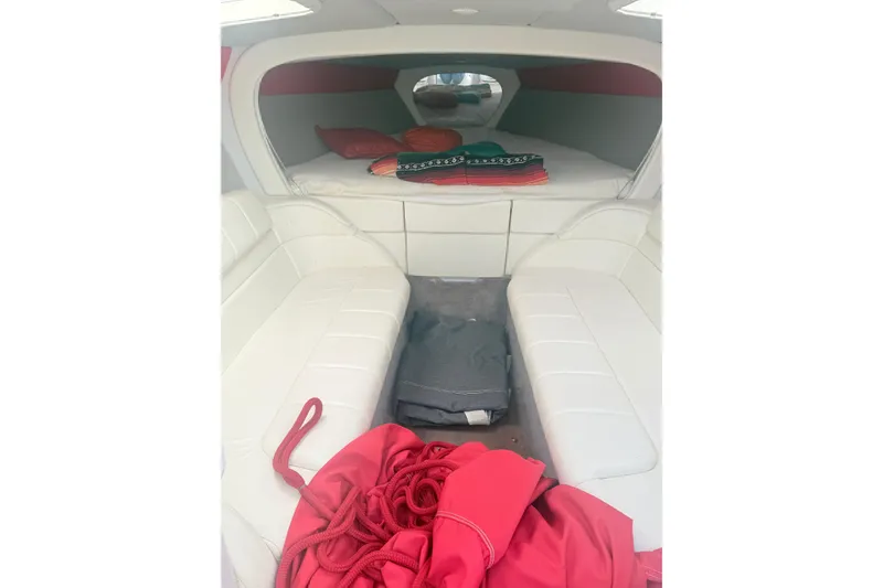 Slide: The Image of Interior of a 1999 Formula 312 FASTech boat with white seating and red accents. - 16