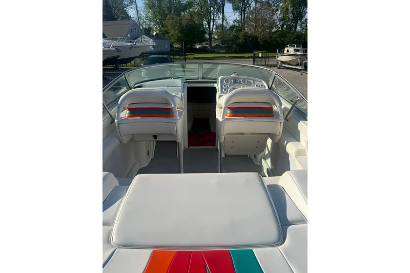 Slide: The Image of Interior of a 1999 Formula 312 FASTech boat with white seating and colorful accents. - 17