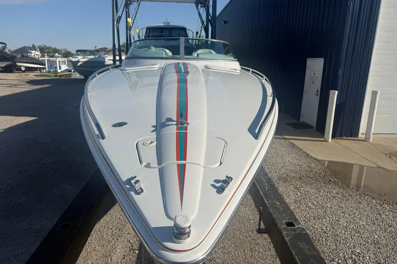 Slide: The Image of 1999 Formula 312 FASTech boat on trailer, white with red and green stripe. - 18