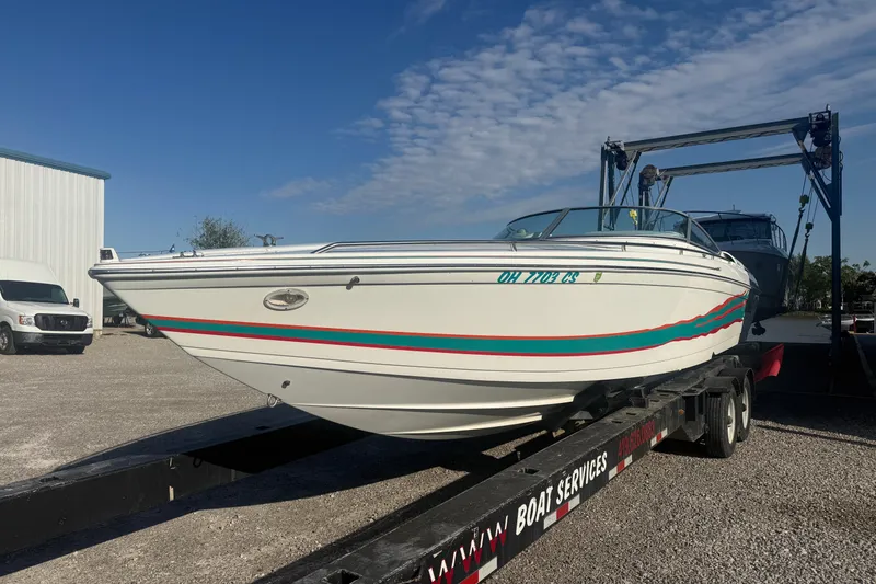 Slide: The Image of 1999 Formula 312 FASTech boat on trailer under clear blue sky. - 19