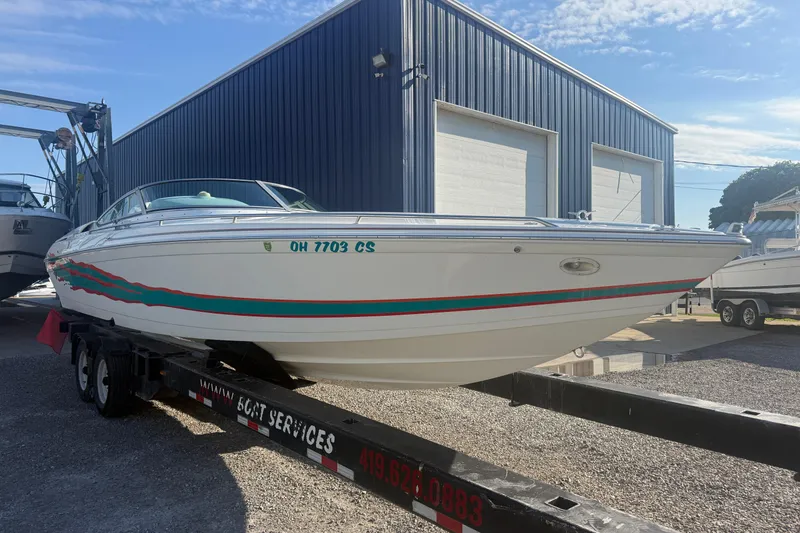 Slide: The Image of 1999 Formula 312 FASTech boat on trailer near blue warehouse. - 20