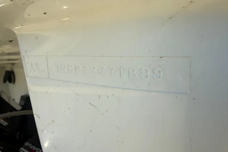 Slide: The Image of 1999 Formula 312 FASTech boat hull identification number embossed on white surface. - 21
