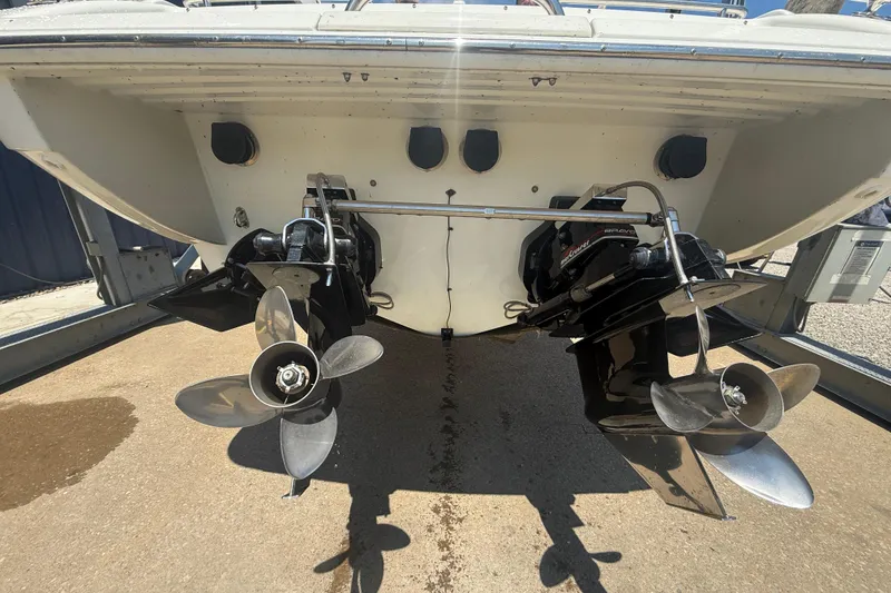 Slide: The Image of 1999 Formula 312 FASTech boat with dual propellers and outboard motors in a dry dock. - 23