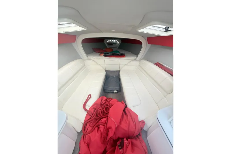 Slide: The Image of Interior of a 1999 Formula 312 FASTech boat with white seating and red accents. - 5