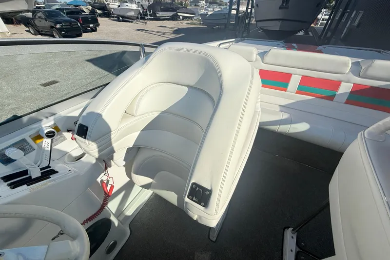 Slide: The Image of 1999 Formula 312 FASTech boat interior with white seating and control panel. - 6