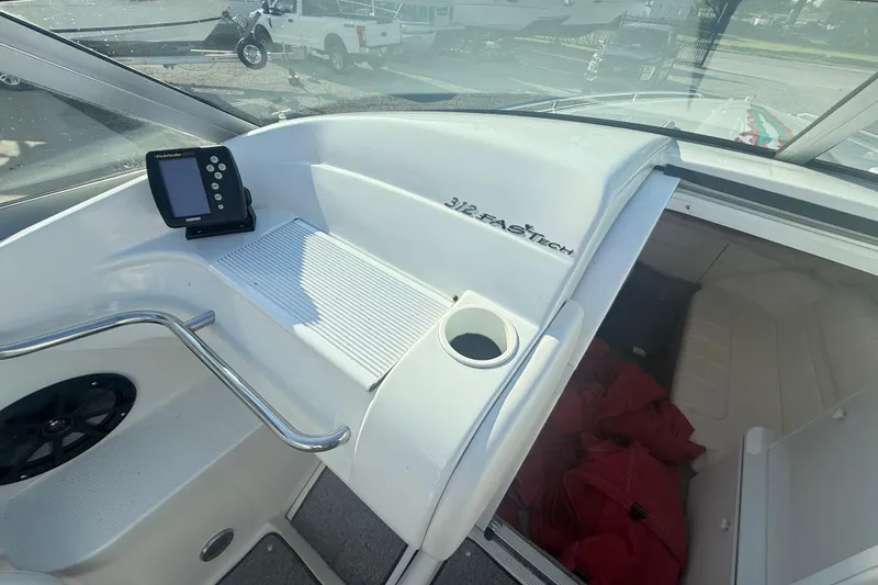 Slide: The Image of 1999 Formula 312 FASTech boat interior with control panel and seating area. - 8