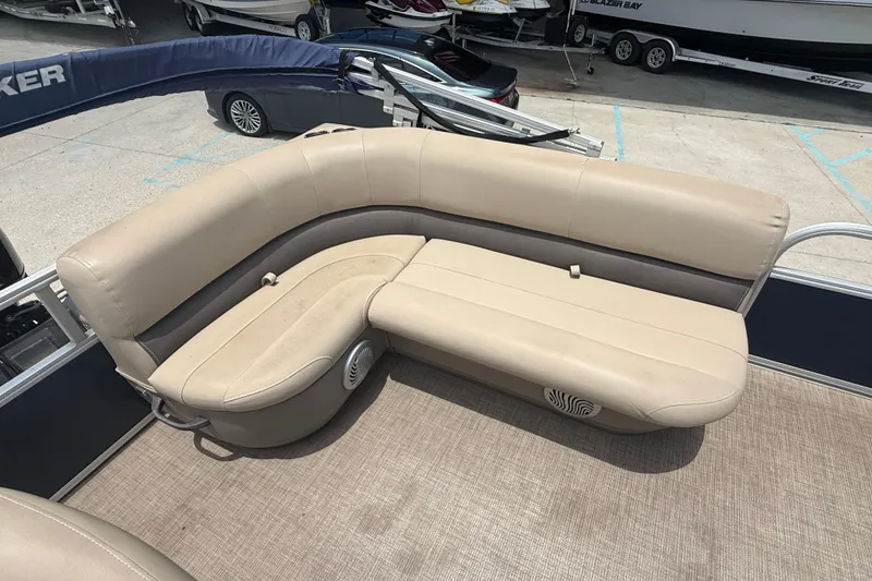 Slide: The Image of 2022 Sun Tracker Bass Buggy 16 DLX pontoon boat with beige seating and spacious deck. - 10