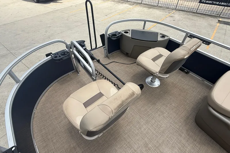 Slide: The Image of 2022 Sun Tracker Bass Buggy 16 DLX pontoon boat interior with seating and control panel. - 11