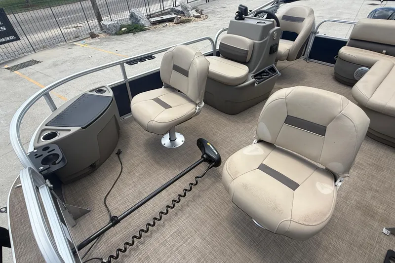 Slide: The Image of 2022 Sun Tracker Bass Buggy 16 DLX interior with beige seating and fishing equipment. - 12