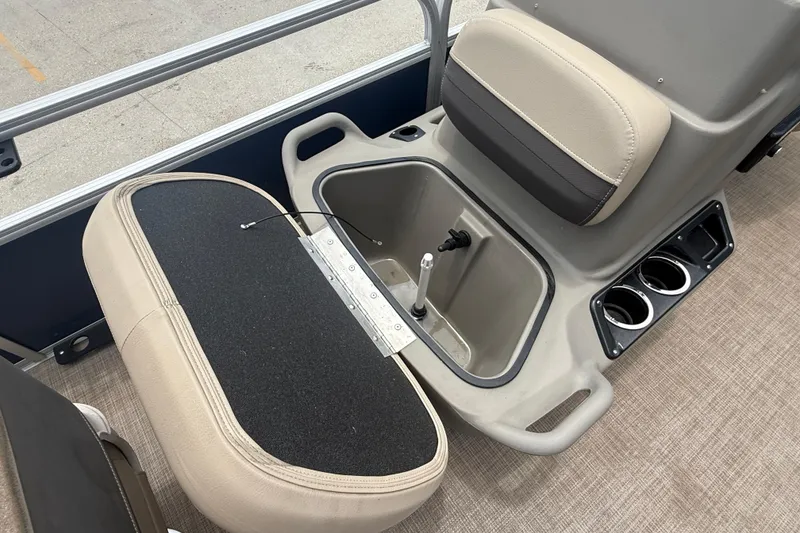 Slide: The Image of 2022 Sun Tracker Bass Buggy 16 DLX interior with storage compartment and cup holders. - 13