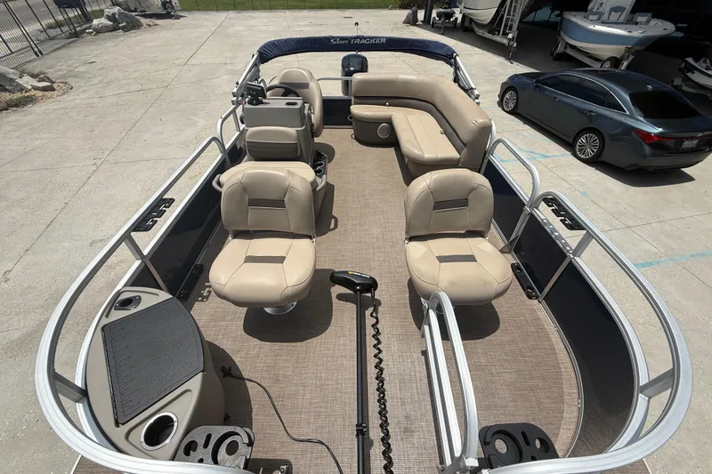 Slide: The Image of 2022 Sun Tracker Bass Buggy 16 DLX pontoon boat with beige seating and spacious deck. - 6