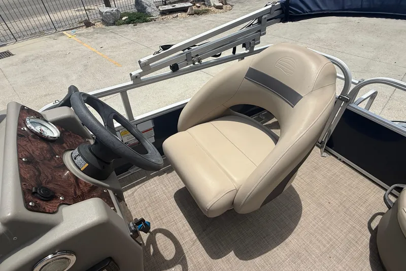 Slide: The Image of 2022 Sun Tracker Bass Buggy 16 DLX boat interior with steering wheel and captain's chair. - 8