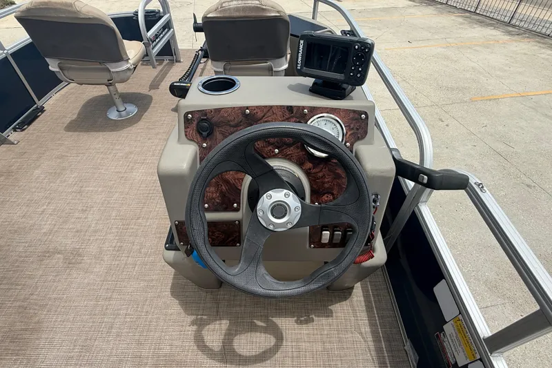 Slide: The Image of 2022 Sun Tracker Bass Buggy 16 DLX steering console with fish finder and seating. - 9