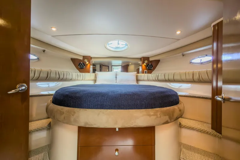Slide: The Image of Luxurious interior of a 2005 Meridian 411 Sedan yacht, featuring a cozy bedroom. - 10