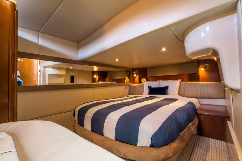 Slide: The Image of Luxurious bedroom interior of 2005 Meridian 411 Sedan yacht with striped bedding. - 11