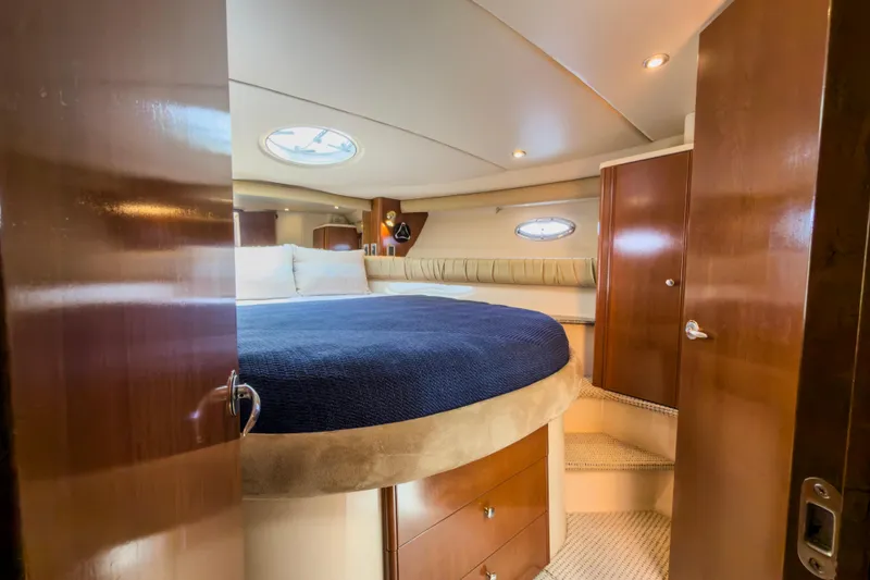 Slide: The Image of Luxurious interior of 2005 Meridian 411 Sedan yacht with cozy bedroom and elegant wood finishes. - 12