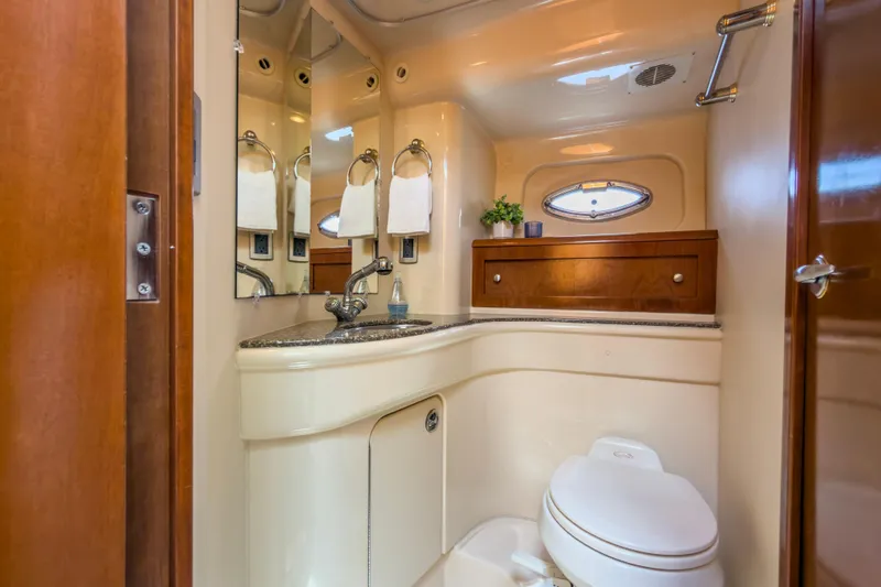 Slide: The Image of Luxurious bathroom in 2005 Meridian 411 Sedan yacht with elegant fixtures and wood accents. - 14