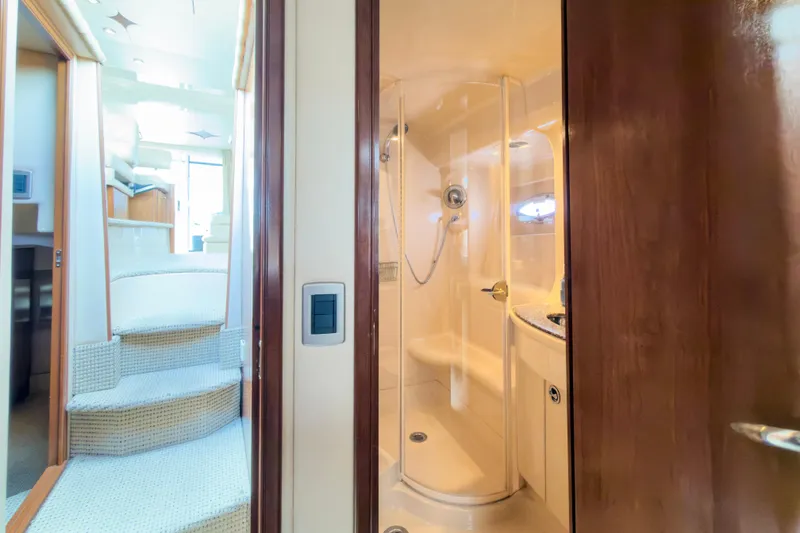 Slide: The Image of Interior of 2005 Meridian 411 Sedan yacht featuring a compact bathroom and staircase. - 15