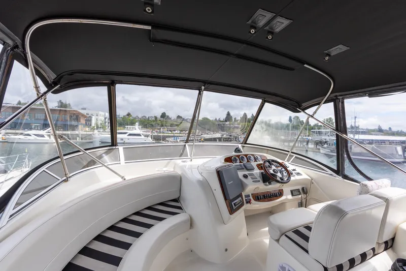 Slide: The Image of Interior view of 2005 Meridian 411 Sedan yacht cockpit with marina backdrop. - 16