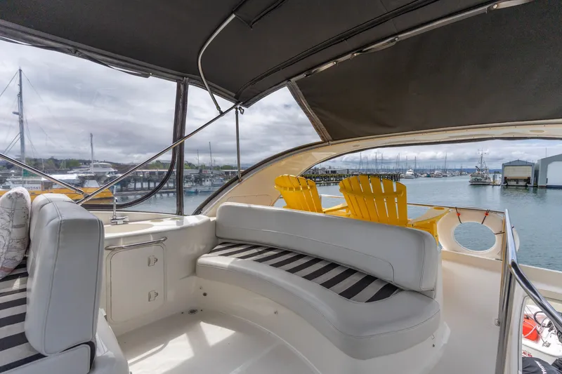 Slide: The Image of Luxurious 2005 Meridian 411 Sedan yacht interior with marina view, featuring comfortable seating. - 17