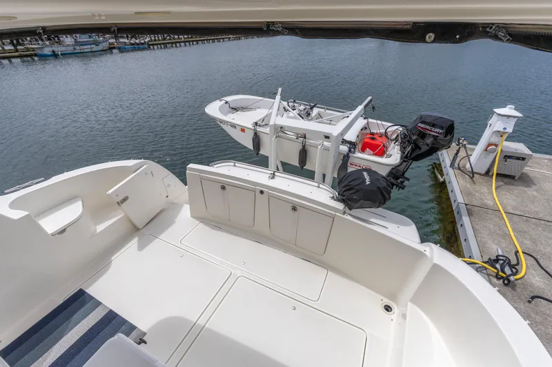 Slide: The Image of 2005 Meridian 411 Sedan yacht with docked dinghy and Mercury outboard motor. - 20