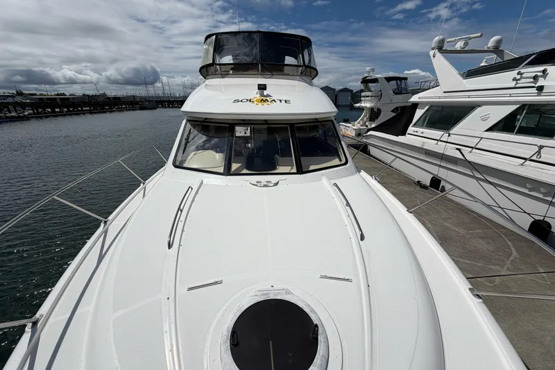 Slide: The Image of 2005 Meridian 411 Sedan yacht docked at marina under cloudy sky. - 22