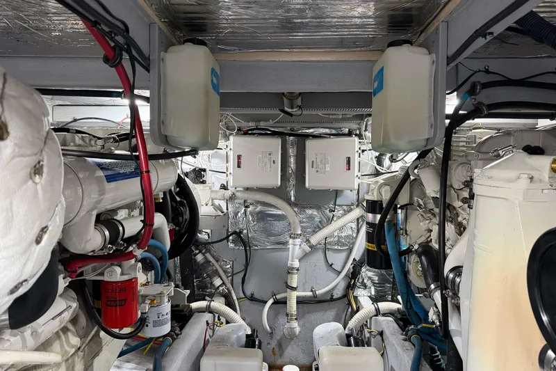 Slide: The Image of Engine room of a 2005 Meridian 411 Sedan yacht, showcasing mechanical components and wiring. - 24