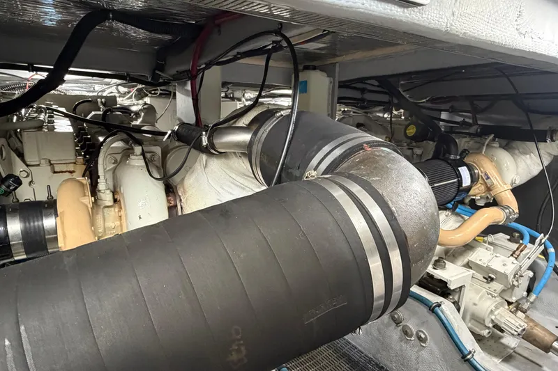 Slide: The Image of Engine room of a 2005 Meridian 411 Sedan yacht, showcasing mechanical components and piping. - 25