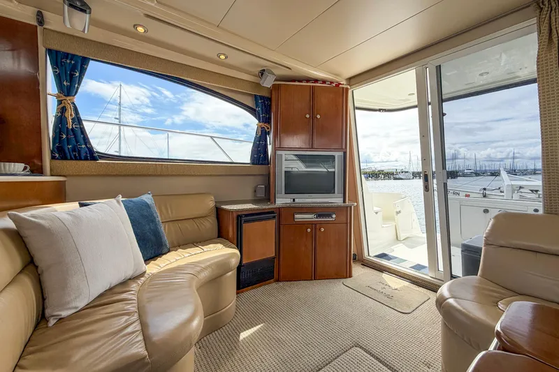Slide: The Image of Luxurious interior of a 2005 Meridian 411 Sedan yacht with leather seating and marina view. - 3