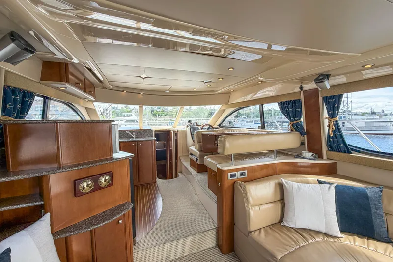 Slide: The Image of Luxurious interior of a 2005 Meridian 411 Sedan yacht with elegant seating and wood finishes. - 4