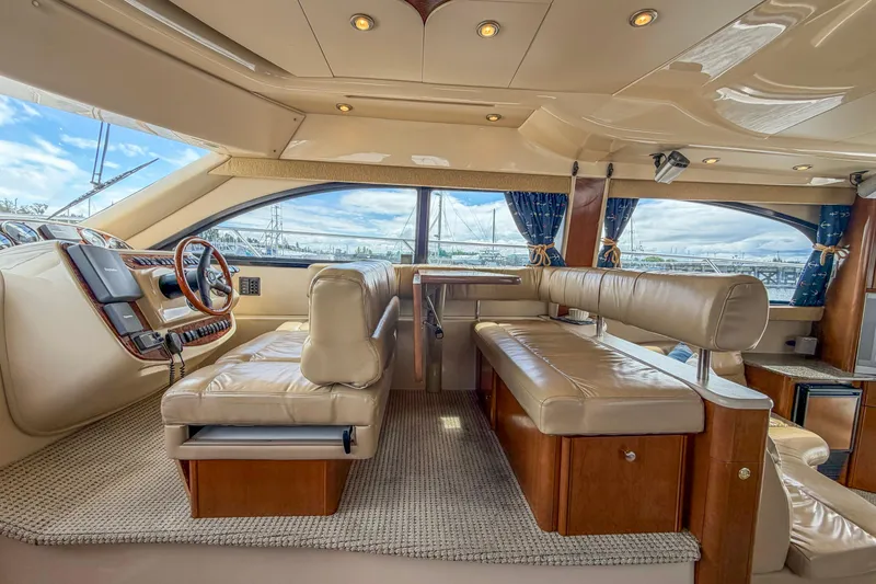Slide: The Image of Luxurious interior of a 2005 Meridian 411 Sedan yacht with plush seating and panoramic windows. - 5