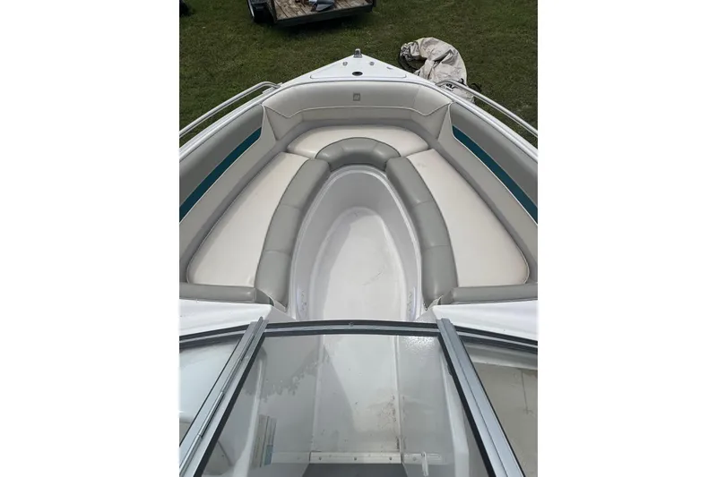 Slide: The Image of 1994 Four Winns 200 Horizon boat interior with cushioned seating and open deck. - 10