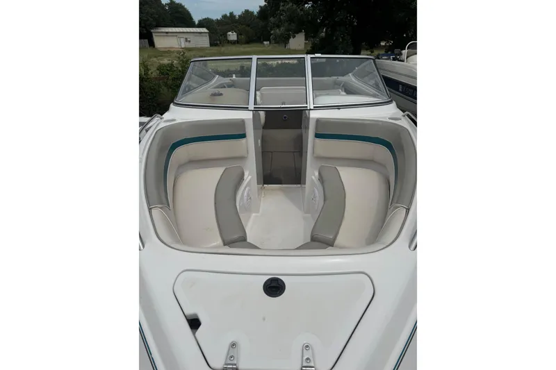 Slide: The Image of 1994 Four Winns 200 Horizon boat interior with white and teal seating. - 11