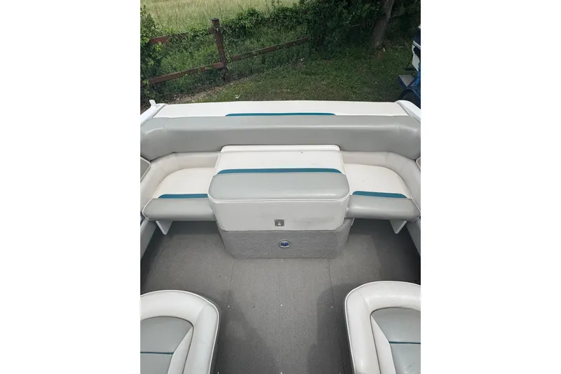 Slide: The Image of 1994 Four Winns 200 Horizon boat interior with white and teal seating. - 13