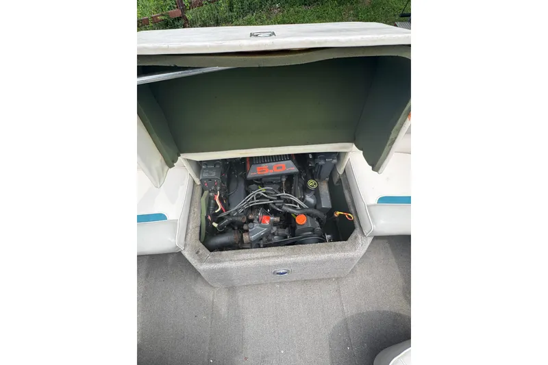 Slide: The Image of Open engine compartment of 1994 Four Winns 200 Horizon boat, showcasing the 5.0 engine. - 15