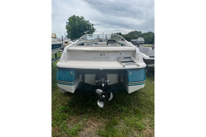 Slide: The Image of 1994 Four Winns 200 Horizon boat, rear view, parked on grass under cloudy sky. - 5