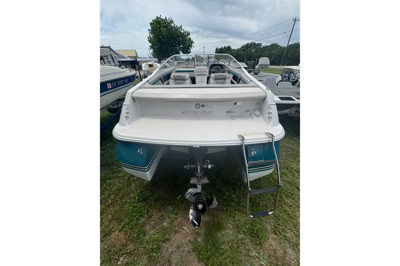 Slide: The Image of 1994 Four Winns 200 Horizon boat, rear view with ladder, parked on grass. - 6