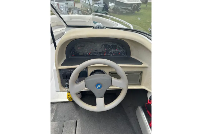 Slide: The Image of 1994 Four Winns 200 Horizon boat dashboard with steering wheel and instrument panel. - 9