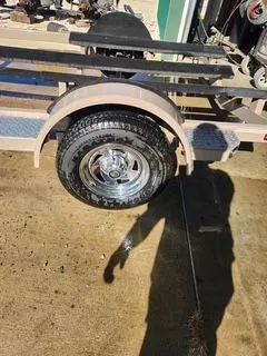 Slide: The Image of Crownline 18 SS 2012 boat trailer with shiny wheel on concrete. - 10