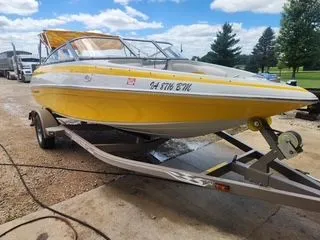 Slide: The Image of Yellow 2012 Crownline 18 SS boat on trailer, sunny day. - 2