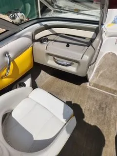 Slide: The Image of Interior of a 2012 Crownline 18 SS boat with yellow accents. - 9